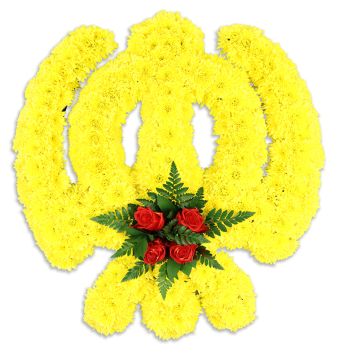 Dominating a clean white field, this floral Khanda is assembled from a dense carpet of bright yellow chrysanthemums that have been shaped with measured skill into the emblem's defining forms. The circular chakkar emerges from an unbroken ring of golden petals, the central double-edged khanda is modelled as a vertical surge of textured yellow, and the two kirpans flare outward in symmetrical, sword-like curves-all created by tiny, ruffled chrysanthemum heads seated closely to one another to produce a soft, tactile surface. The collective warmth of the yellow gives the piece an aura of light and hope while retaining the symbol's solemn dignity.

At the point where the elements converge, a focal cluster of five deep red roses is placed deliberately, each rose tight and glossy, set within a nest of dark green fern fronds that provide both contrast and a sense of shelter. The composition casts a faint shadow on the white plane, reinforcing its presence as a tangible tribute-appropriate for memorial services, Sikh religious ceremonies, or commemorations across Charlton and nearby Greenwich or Woolwich. The overall impression is one of disciplined floral artistry: colours that speak of remembrance and respect, textures that invite a closer look, and a scent that is quietly floral-crafted with the steadiness of a local florist who understands both community custom and ceremonial need.